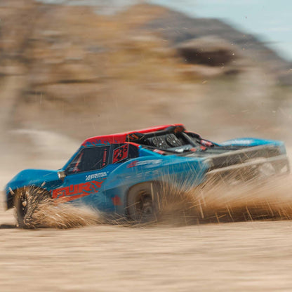 ARRMA FURY 223S BLX blue short course truck sliding through loose dirt