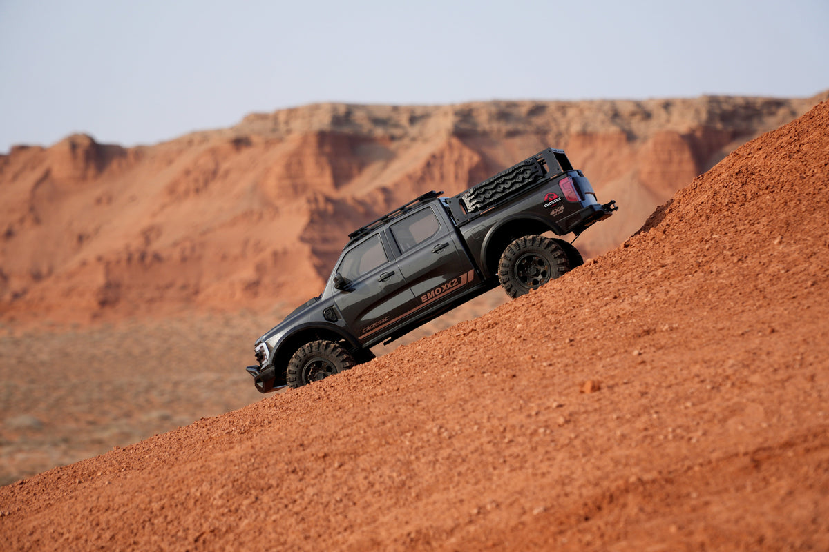 CROSSRC EMO XX2 1/5 Gunmetal climbing a steep dirt grade