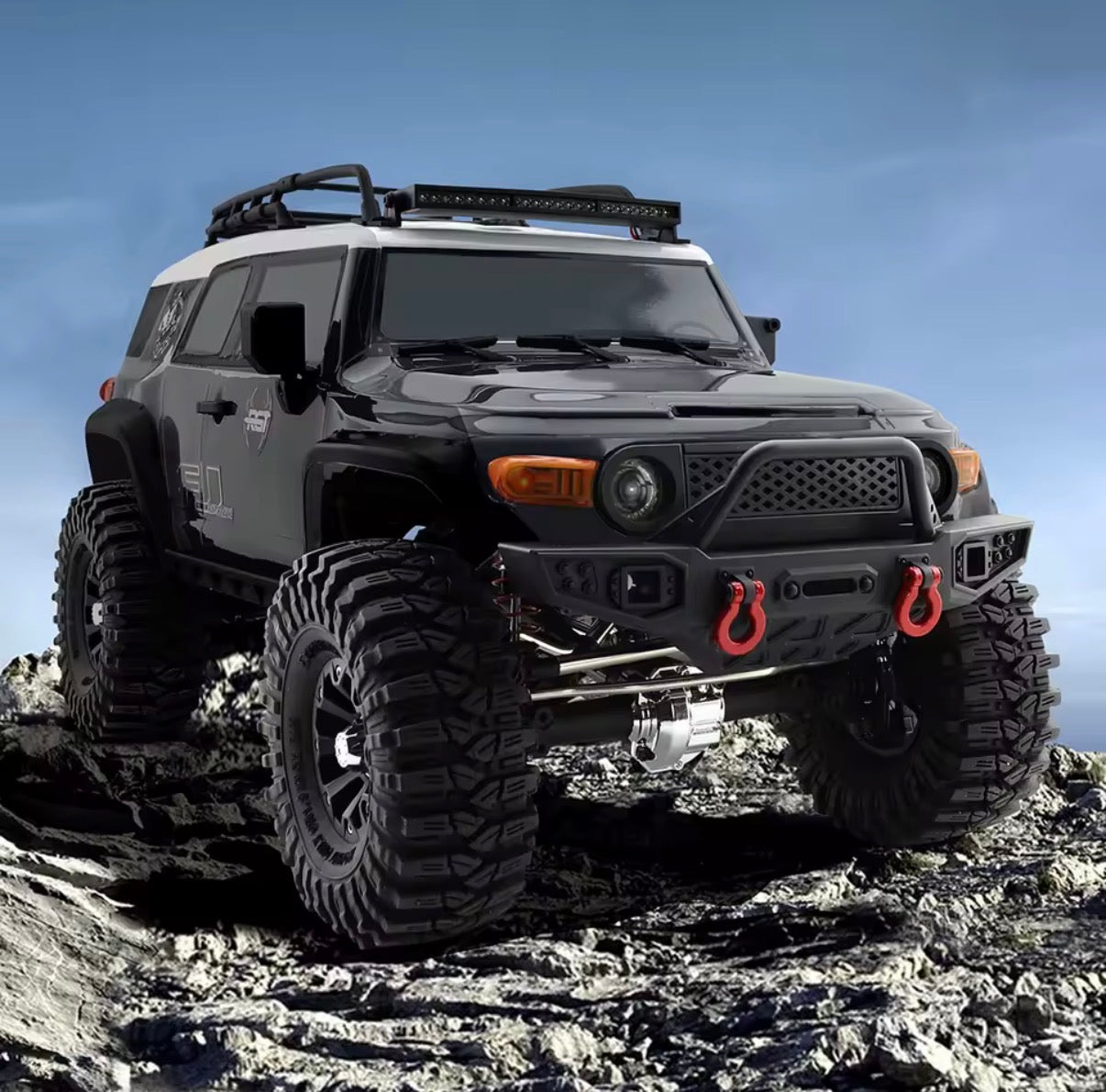RGT EX86120 FJ Desert Fox black crawler on rocky terrain